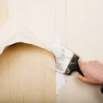 Removal of old wallpapers with spatula